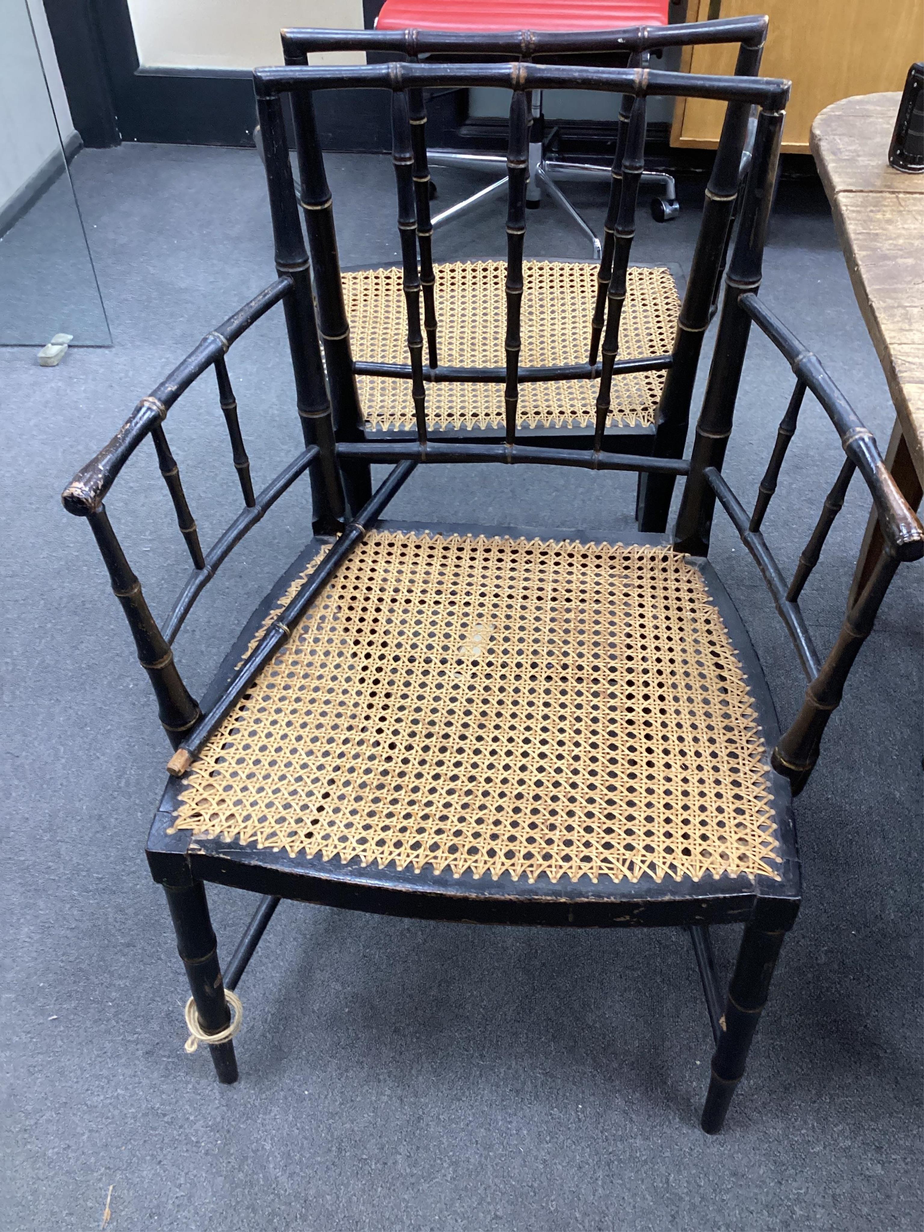 A set of four Regency ebonised simulated bamboo cane seat elbow chairs, width 56cm, depth 43cm, height 86cm. Condition - fair (one stretcher detached but present)